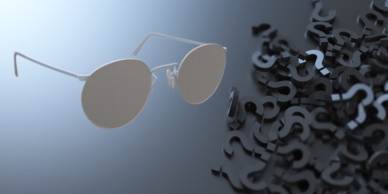 Glasses next to a pile of question marks